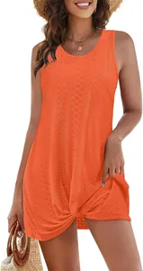 Close-up of orange hollow-out summer beach vacation dress with twisted knot hem detail