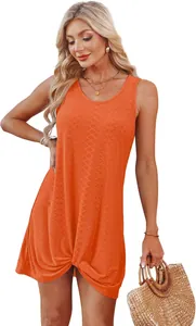 Detail view of vibrant orange hollow-out summer beach dress with stylish twist knot hem