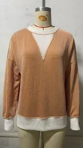 Detailed view of a casual loose-fit color-block striped sweatshirt on a mannequin prop
