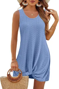 Detail view of blue eyelet hollow-out fabric and front knot hem on a summer dress.