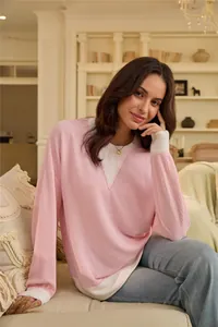 Model wearing a casual pink color-block waffle knit long sleeve top in a home setting