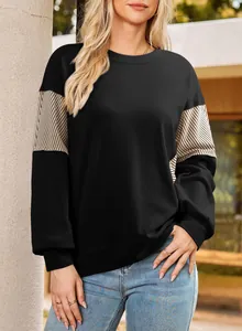 Detail view of casual black sweatshirt featuring elegant striped sleeve paneling.