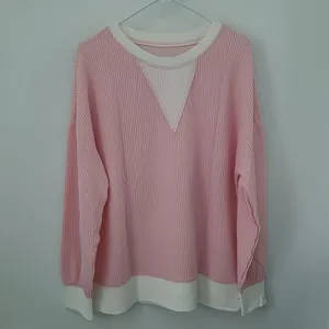 Pink and white color-block sweatshirt with ribbed texture and crew neck detail