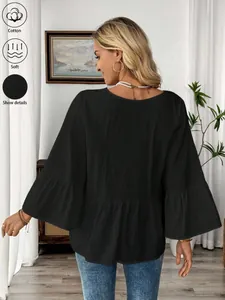 Rückansicht der schwarzen Baumwollbluse mit eleganten Volantärmeln und weicher Textur