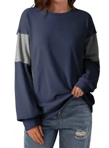 Close-up of casual women's navy blue sweatshirt with striped sleeve patchwork details