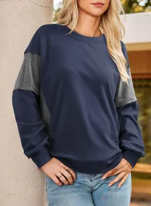 Detail of women's navy blue crewneck sweatshirt with striped contrast sleeve panels
