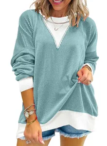 Close-up of women's waffle knit sweatshirt with teal and white color blocking