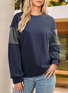 Detail view of a navy blue long-sleeve sweatshirt with grey striped sleeve inserts.