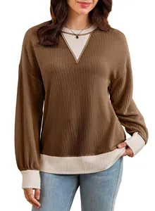 Detail view of women's brown waffle knit sweatshirt featuring contrast cream V-neck insert