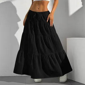 Detail of black tiered maxi skirt with drawstring waist and relaxed fit for summer