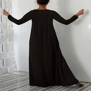Back view of a minimalist black long-sleeve maxi dress with a loose flowing silhouette.