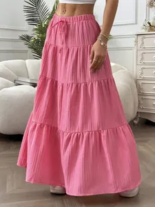 Detailed view of women's pink tiered maxi skirt with drawstring waist and crinkle texture