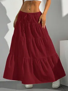 Close-up detail of burgundy tiered bohemian maxi skirt showing the rich fabric texture