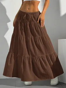 Detailed view of women's brown tiered maxi skirt with bohemian flowing design.