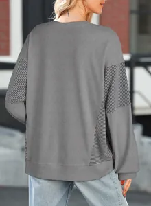 Back view of grey crewneck sweatshirt with striped patchwork sleeve details