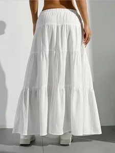 A detailed back view of a white tiered maxi skirt featuring high waist and pleated fabric
