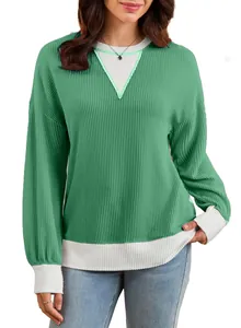 Close-up of green and white waffle knit sweatshirt featuring stylish color-block design