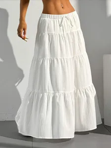 Close-up view showing the textured pleats and tiered layers of a white summer maxi skirt