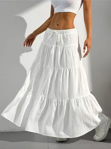 White bohemian tiered maxi skirt with elastic drawstring waist and textured fabric.