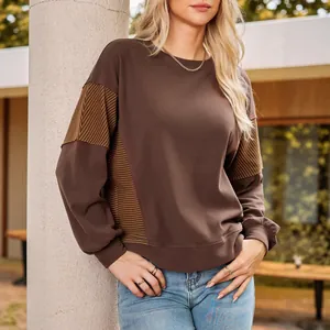 Casual brown crewneck sweatshirt with orange striped patchwork on sleeves and sides