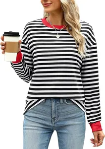 Detail view of women's black and white striped top with red cuffs and neckline