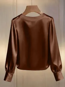 Back view detail of brown satin long sleeve blouse showing luxurious fabric sheen