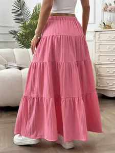 Back view of a casual pink tiered pleated maxi skirt featuring a textured fabric design