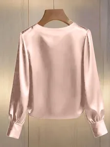 Back view of elegant champagne satin long sleeve blouse with a smooth silky texture