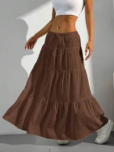 Casual brown tiered maxi skirt featuring a flowy hem and an elastic drawstring waist