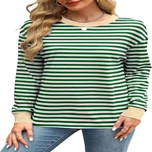 Detail of a green and white striped long sleeve top with a beige contrast crew neck.