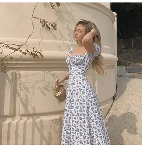 Side view detail of a floral midi dress with a square neckline and puff sleeves