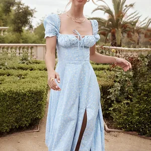 Close-up of a blue floral square neck maxi dress with puff sleeves and front slit details