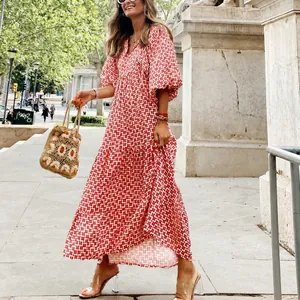 Detailed view of red geometric print maxi dress with puff sleeves for autumn