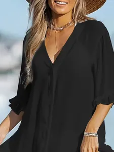 Close-up of black V-neck beach cover-up dress with ruffled sleeves and buttons