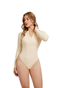 Detail view of a beige long sleeve ribbed bodysuit with Henley button neckline