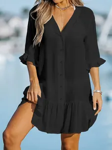 Close-up detail of a minimalist black V-neck button-down ruffled dress for women's beach vacation