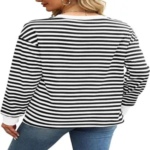 Back view of black and white striped long sleeve top with white cuffs and loose fit.
