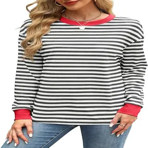 Detailed view of women's black and white striped long sleeve top with red contrast trim