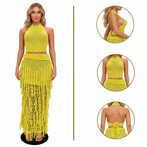 Detailed view of yellow handmade knit halter top and tassel beach skirt set on mannequin