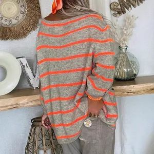 Stylish grey and bright orange horizontal striped knit sweater with loose oversized fit.