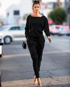 Full-body street view of a women's black urban casual two-piece knit lounge set