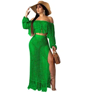 Full body view of a sexy green mesh crochet two-piece beach set with fringe and slit skirt