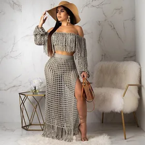Detail shot of boho mesh two-piece beach set featuring fringe trim and high slit skirt