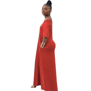 Detailed side view of a solid orange off-shoulder maxi dress with functional side pockets.