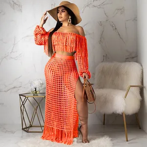 Vibrant orange crochet mesh beach two-piece set featuring tassel details and high slit