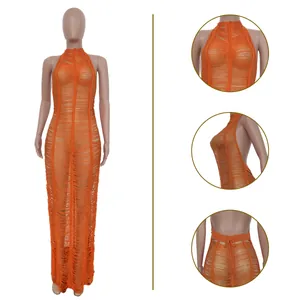 Detail of orange knitted beach maxi dress with shredded texture and halter neck design