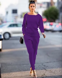 Urban fashion view of a purple knit two-piece set featuring long-sleeve top and pants