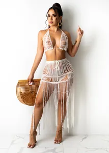 Detailed view of white knit mesh halter top and long fringe beach skirt two-piece set