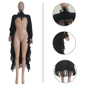 Detailed view of black knitted sweater with long fringe trim and distressed collar