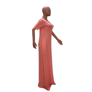 Side view detail of a peach solid color short sleeve maxi dress with side pockets